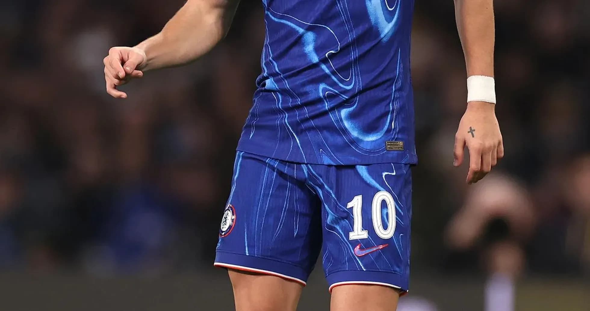 Player in Chelsea kit preparing to kick the ball