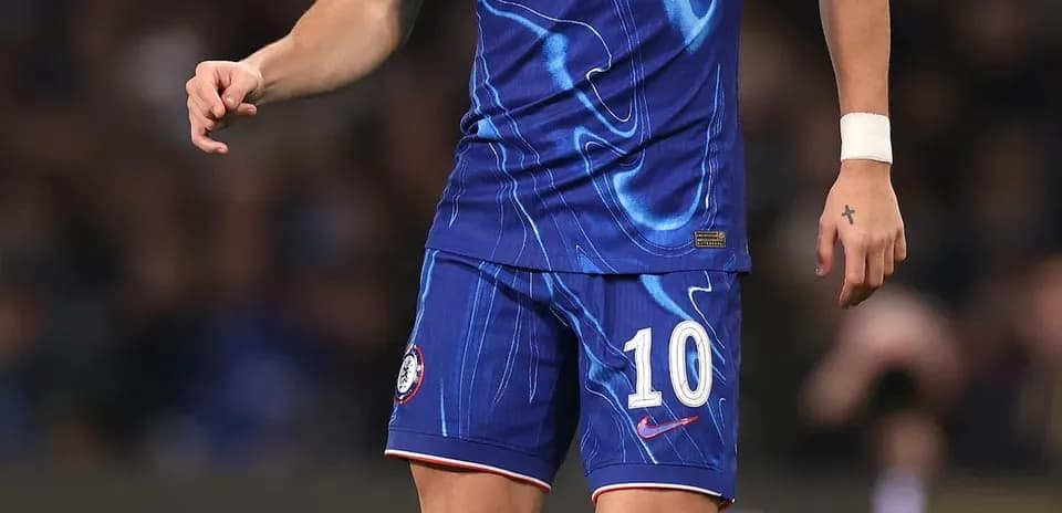 Player in Chelsea kit preparing to kick the ball