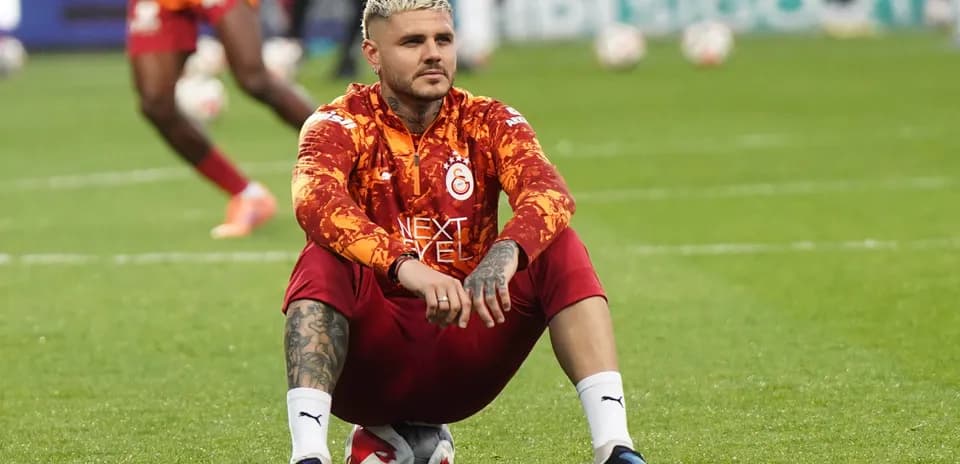 Player sitting on the pitch during warm-up session