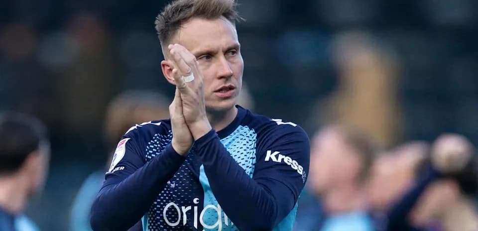 Goalkeeper applauding fans after match conclusion