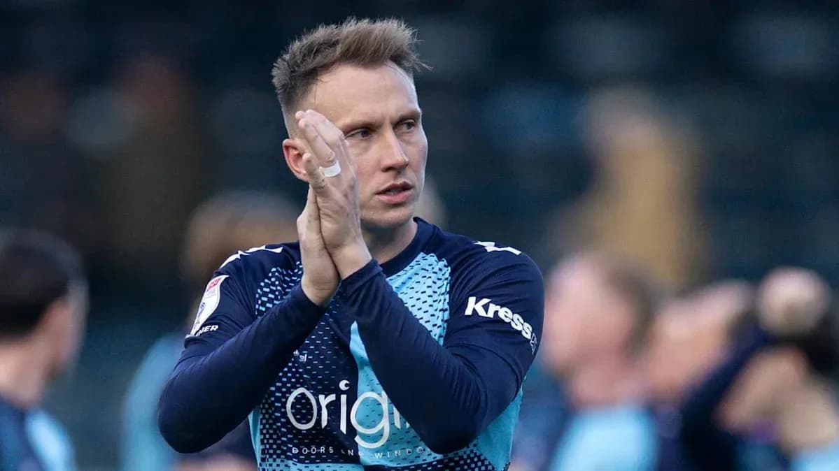 Goalkeeper applauding fans after match conclusion