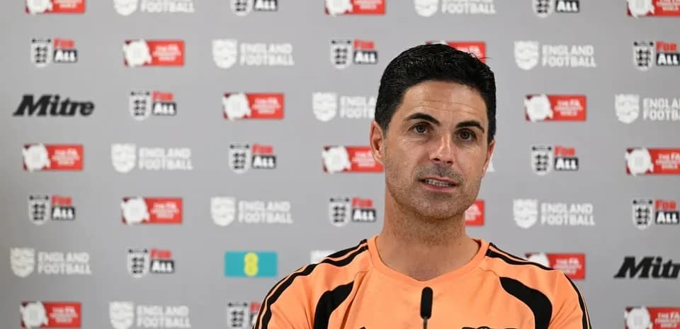Manager speaking at press conference with backdrop