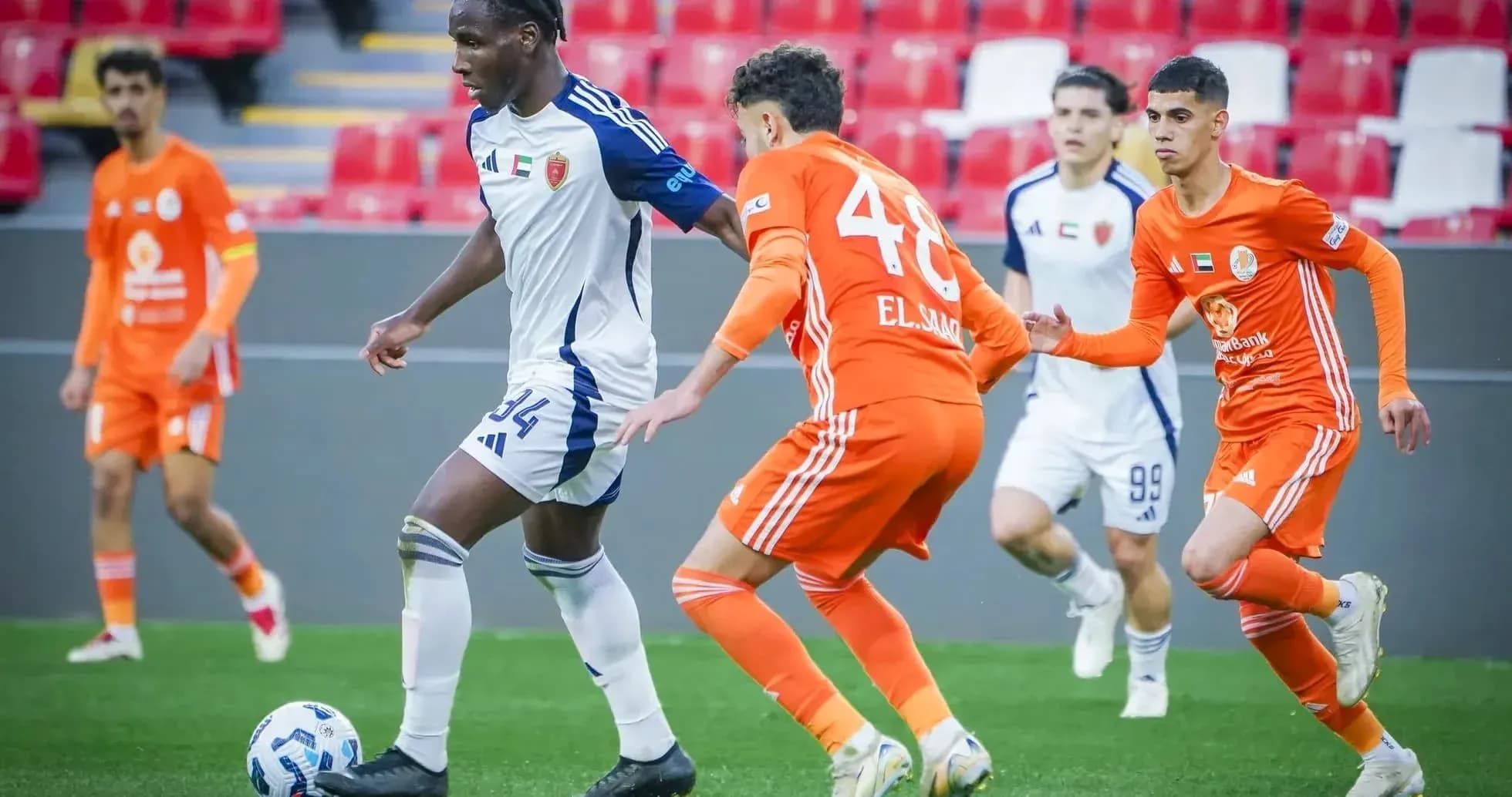 Al Nasr U23 player dribbling against Shabab Al-Ahli U23