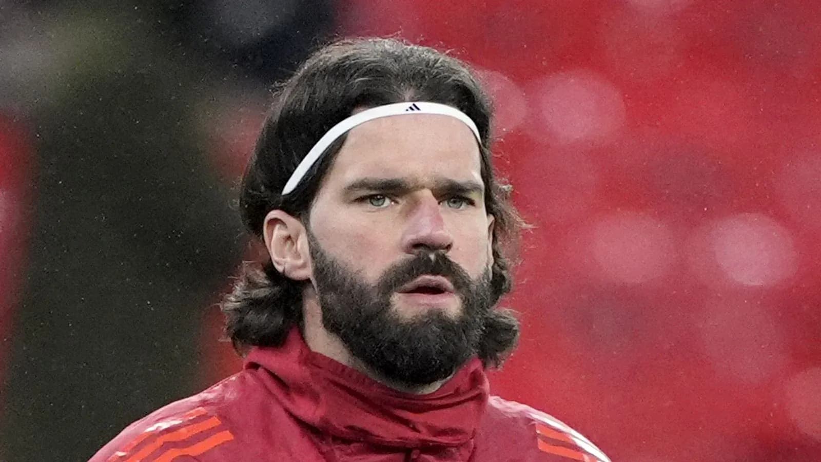 Goalkeeper in red training kit at stadium