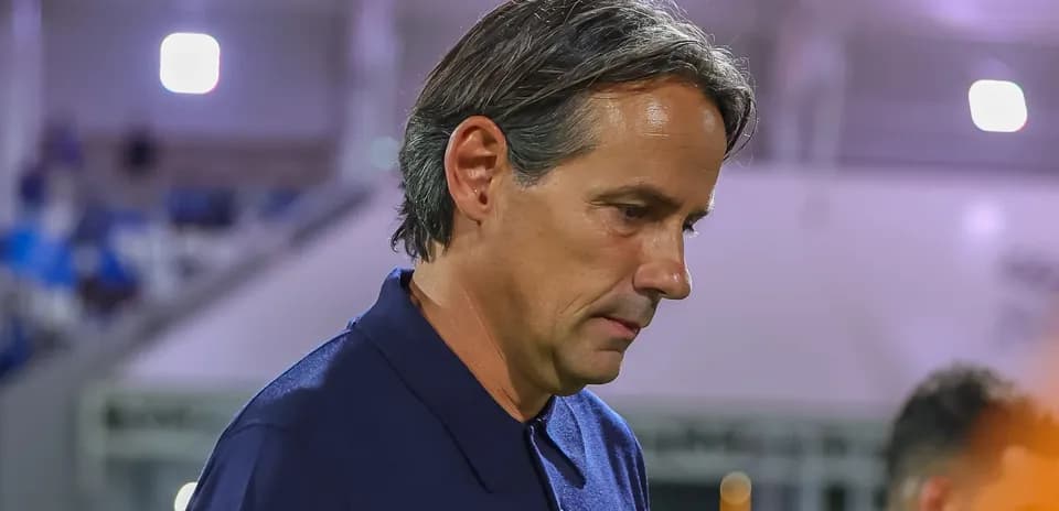 Coach walking off the pitch after match