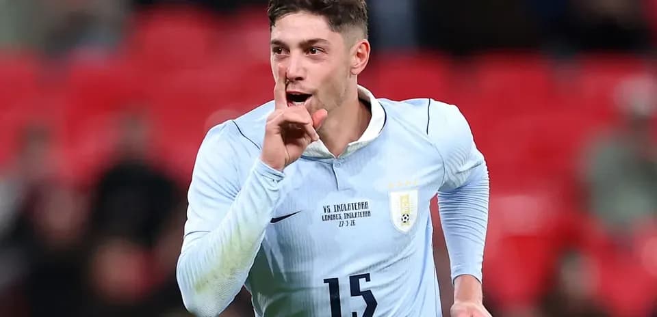 Player celebrating with a shushing gesture after scoring