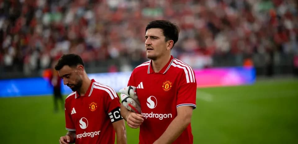 Two Manchester United players walking off the field