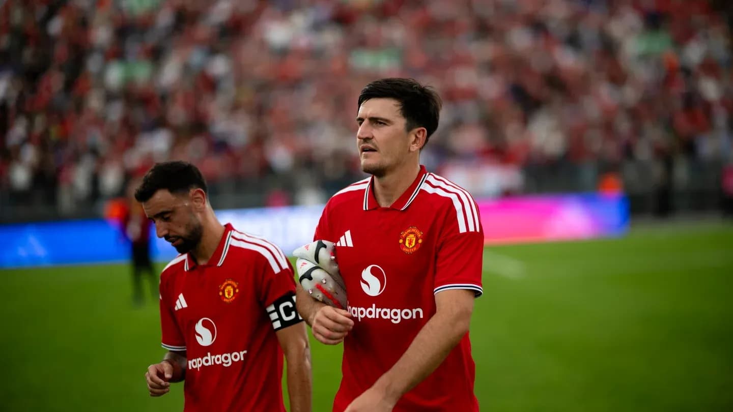 Two Manchester United players walking off the field