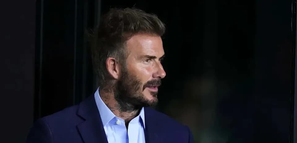 Man in a suit with short hair and beard