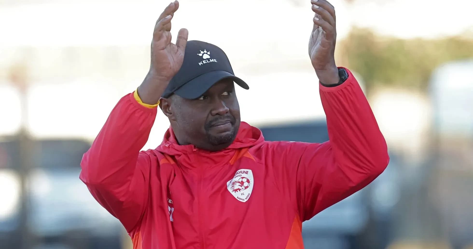 Coach gesturing during training session outdoors