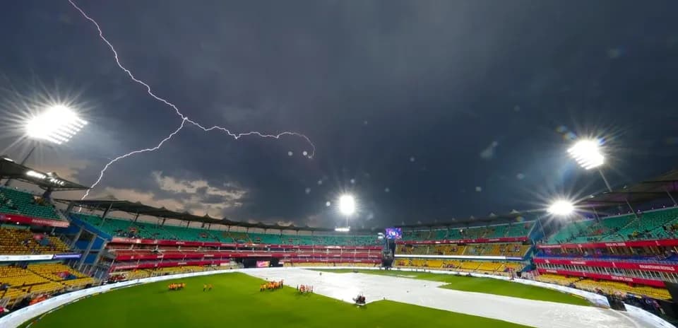 Lightning strikes over covered cricket field in stadium