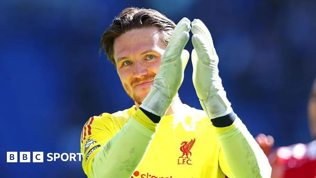 Goalkeeper applauding fans in Liverpool kit