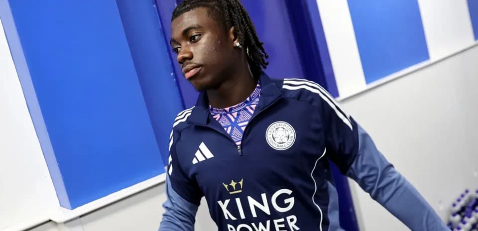 Player entering the locker room wearing Leicester City gear