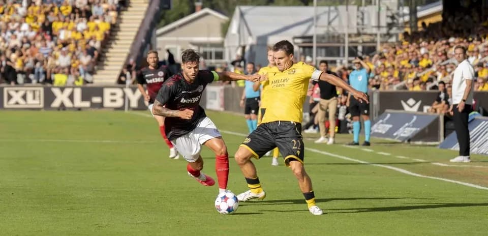 Players competing for the ball in UEFA match