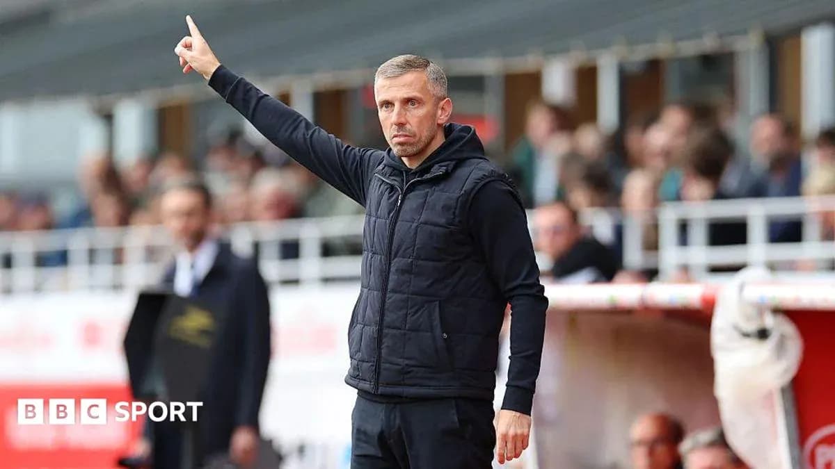 Coach signaling during a football match on sidelines