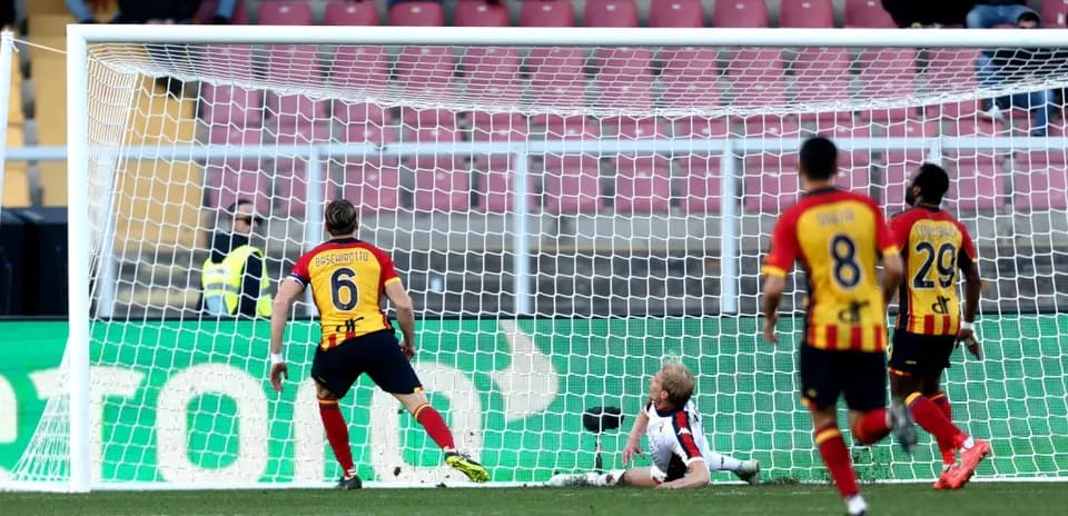 Lecce player scores against Genoa goalkeeper