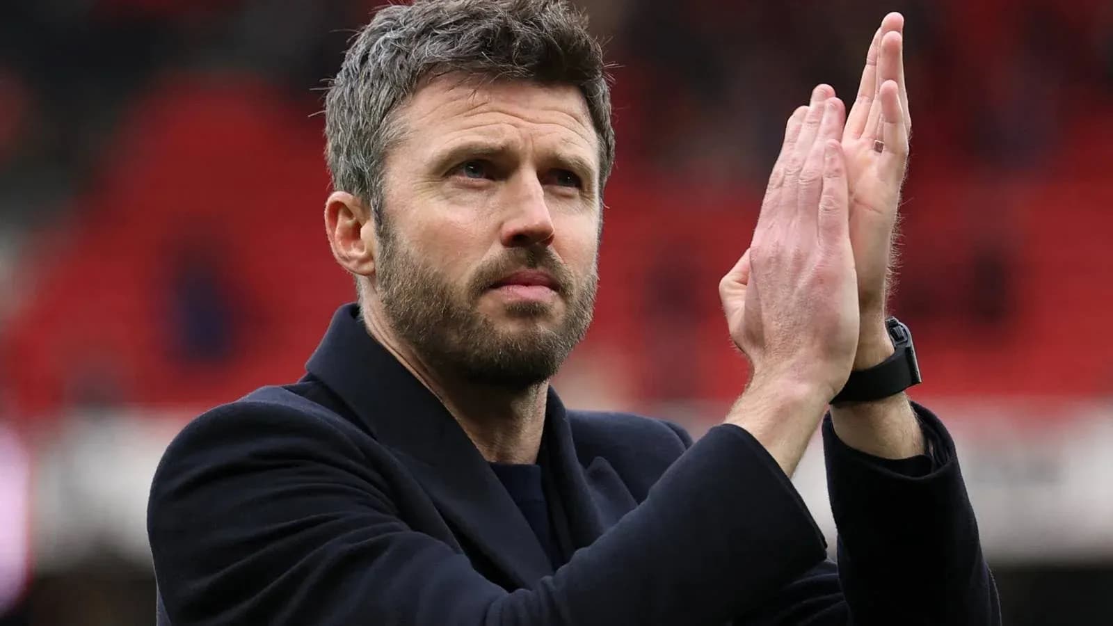 Manager applauding fans after match conclusion