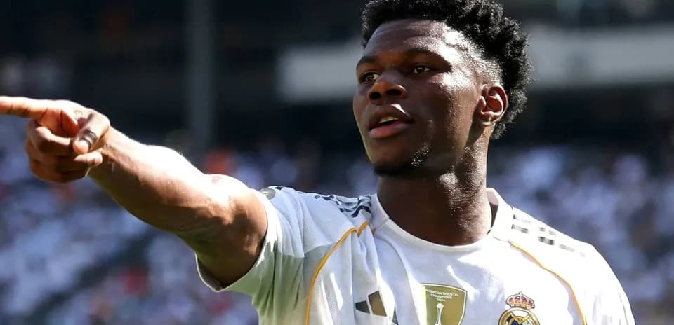 Player gesturing during match wearing Real Madrid jersey