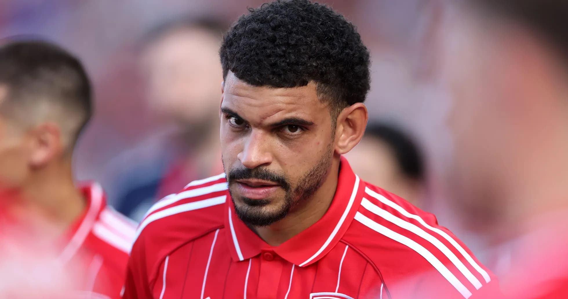 Player in red jersey focused before the match