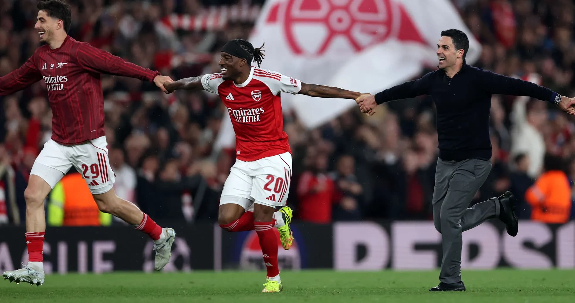 Arsenal players celebrating victory on the pitch
