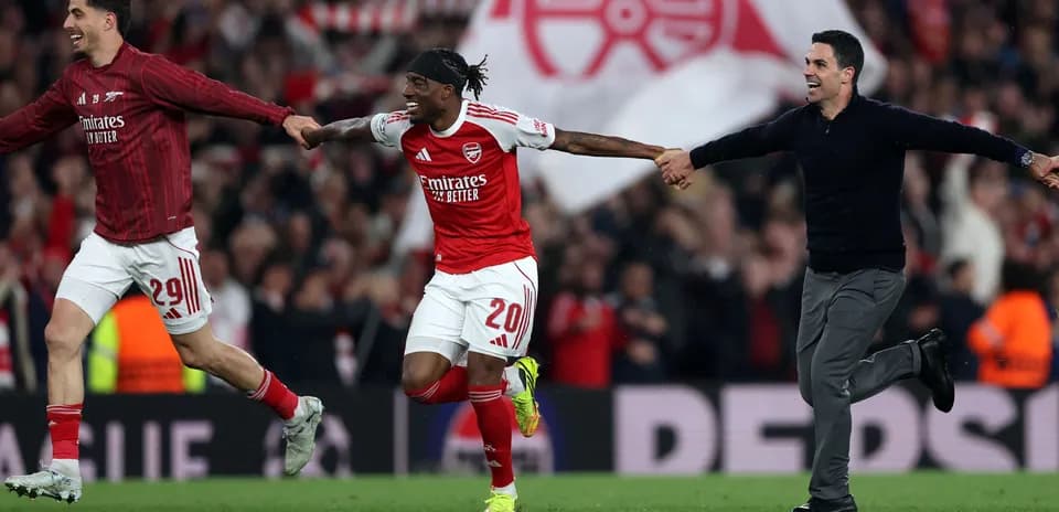 Arsenal players celebrating victory on the pitch