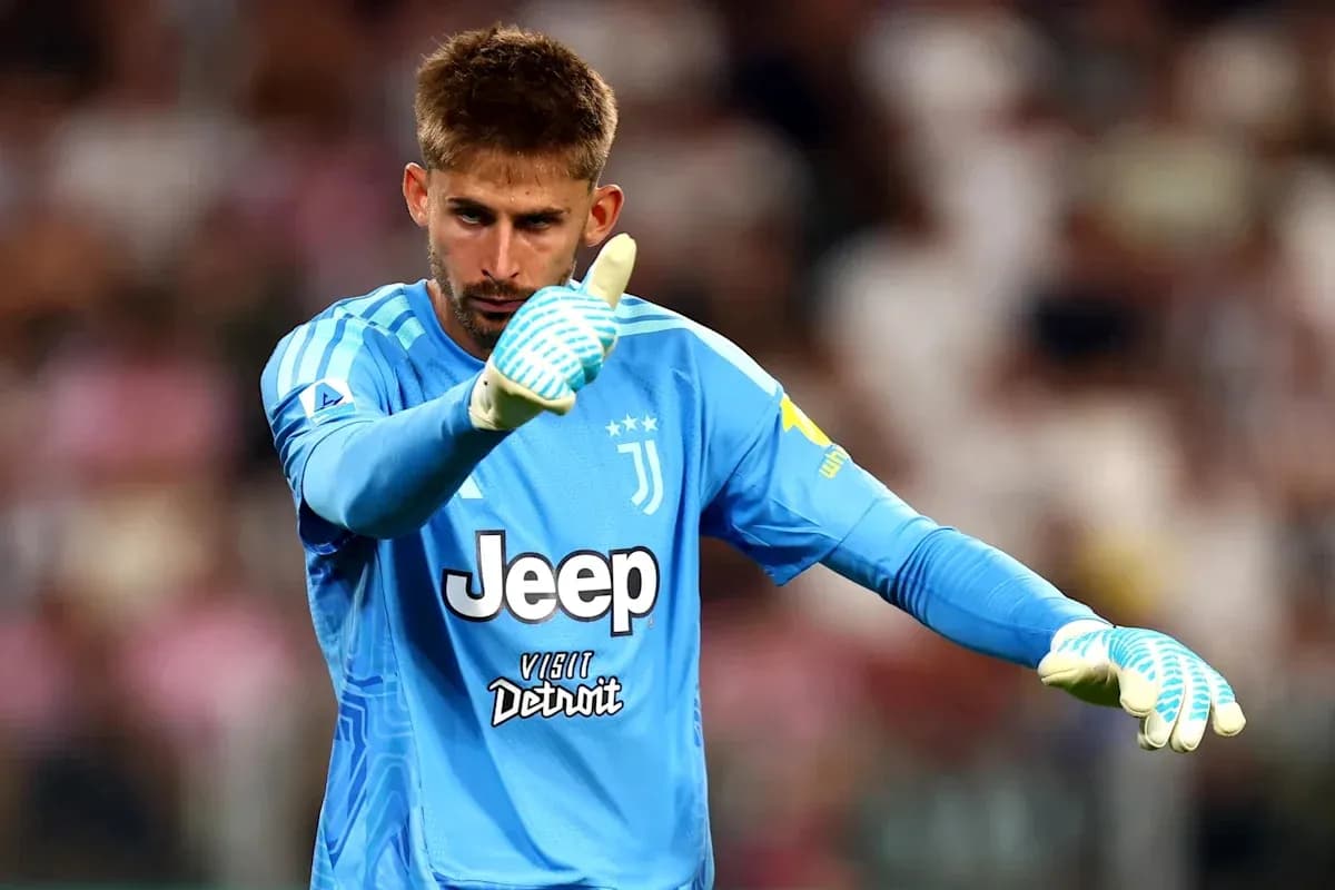 Goalkeeper in blue kit giving thumbs up gesture