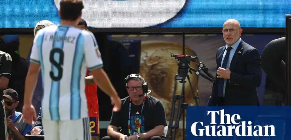 Argentinian player leaving field with coach observing