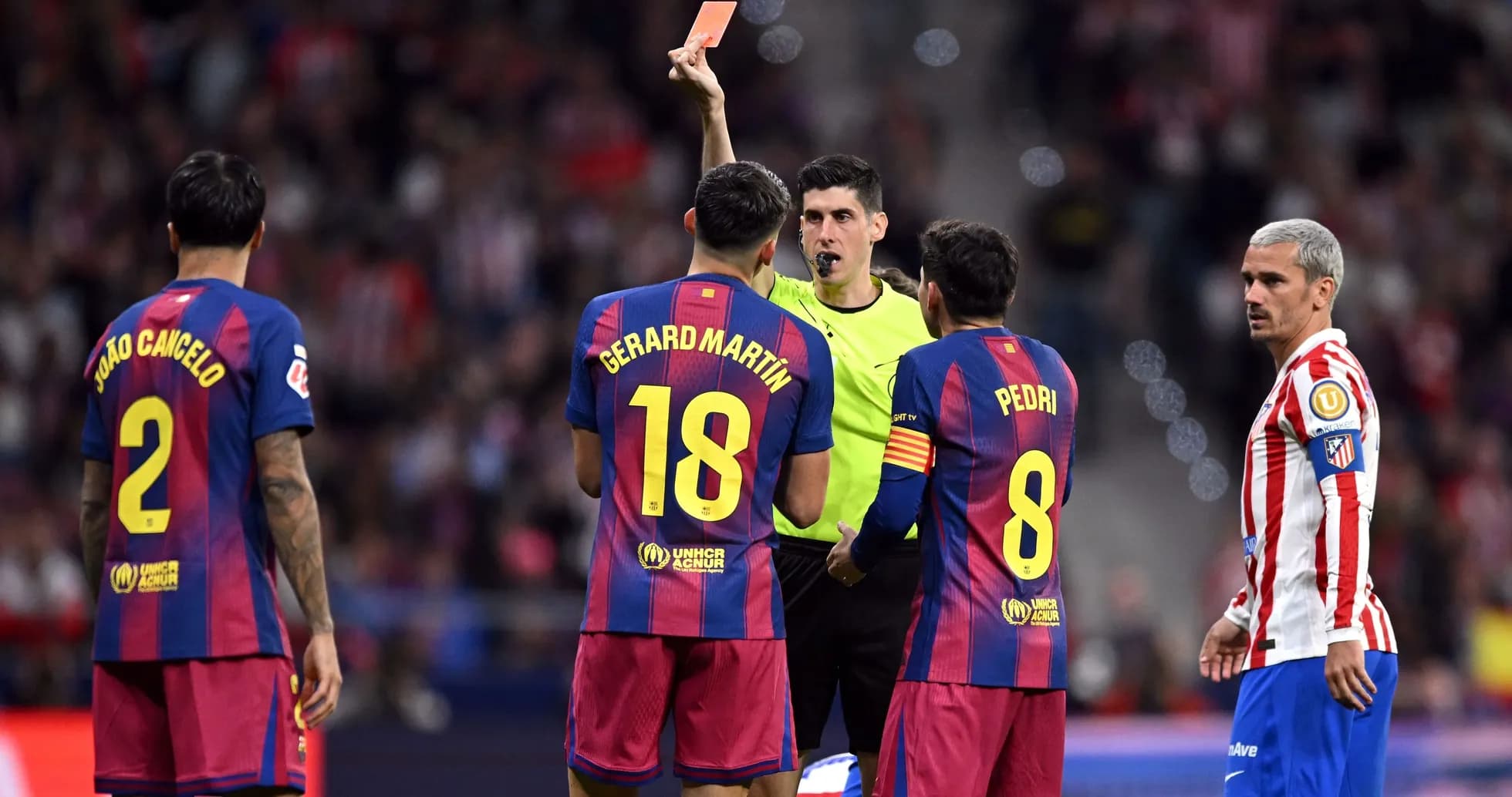 Referee showing red card to Barcelona players