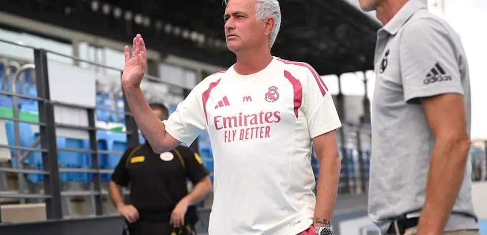 Coach gesturing during conversation on sidelines