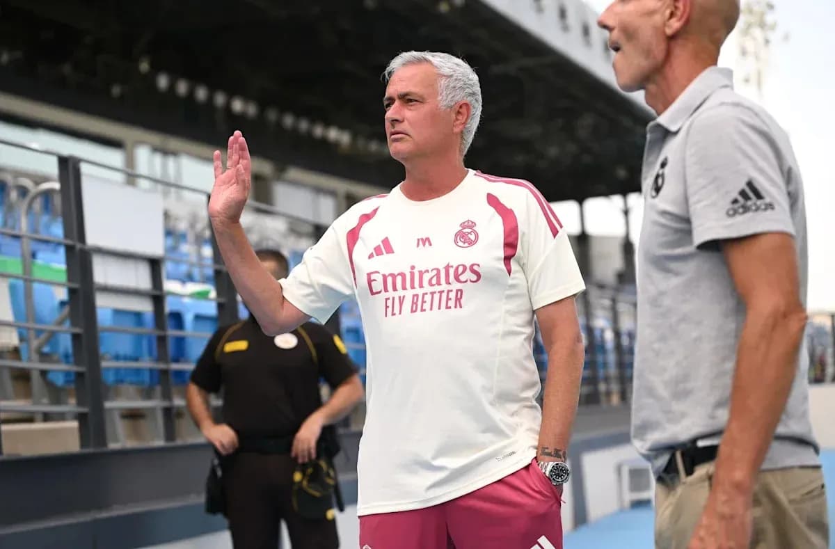 Coach gesturing during conversation on sidelines