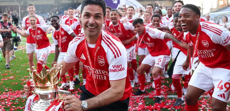 Arsenal team celebrating Premier League victory with trophy
