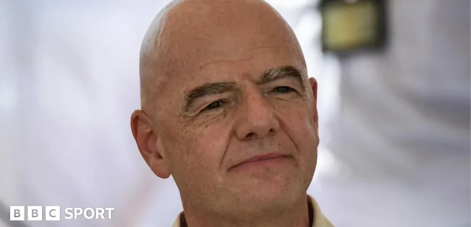 Man with bald head posing for photo outdoors