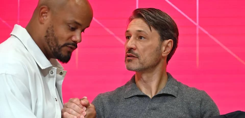 Two men shaking hands at a press event