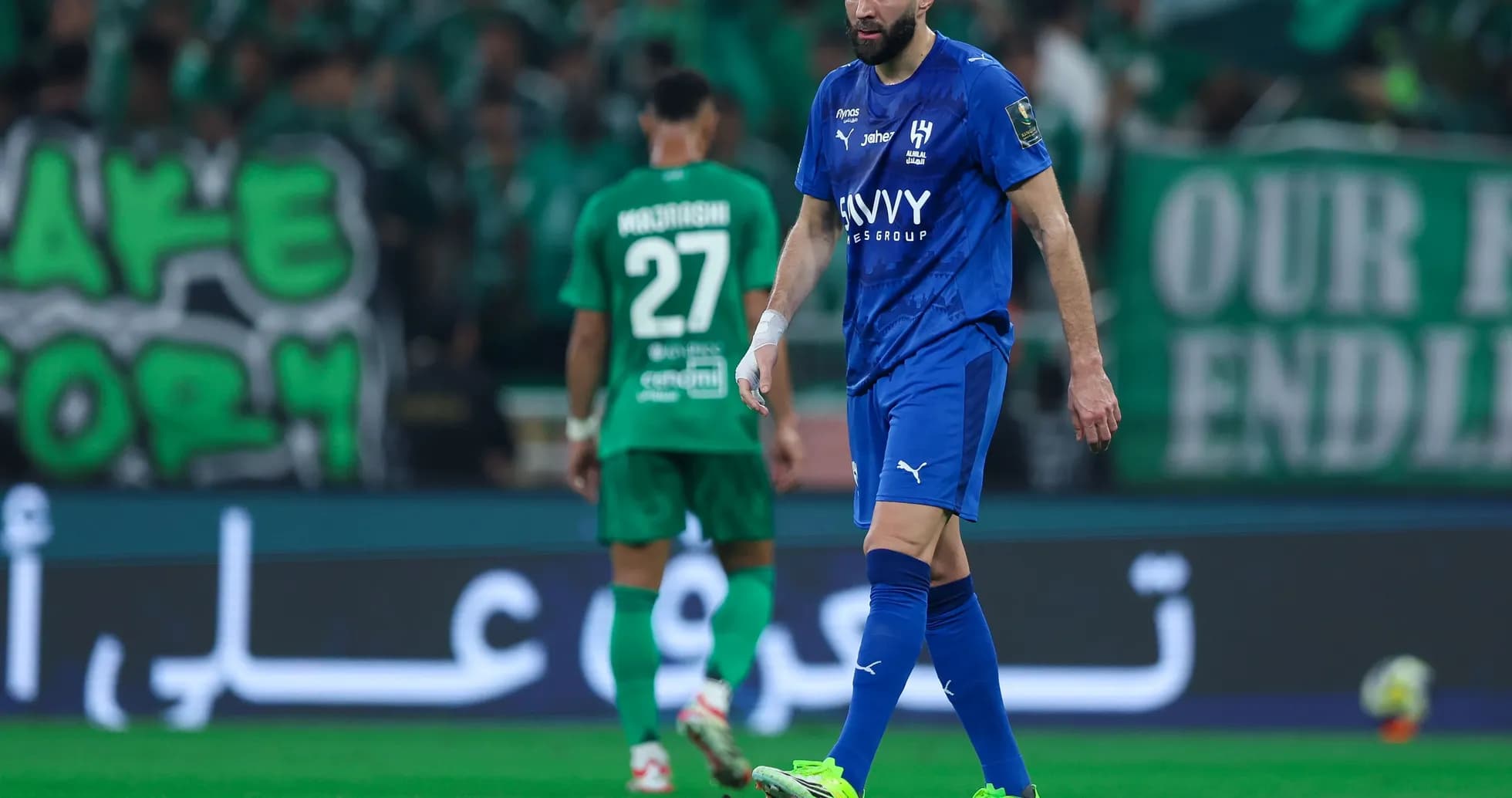 Player in blue jersey walking on the pitch