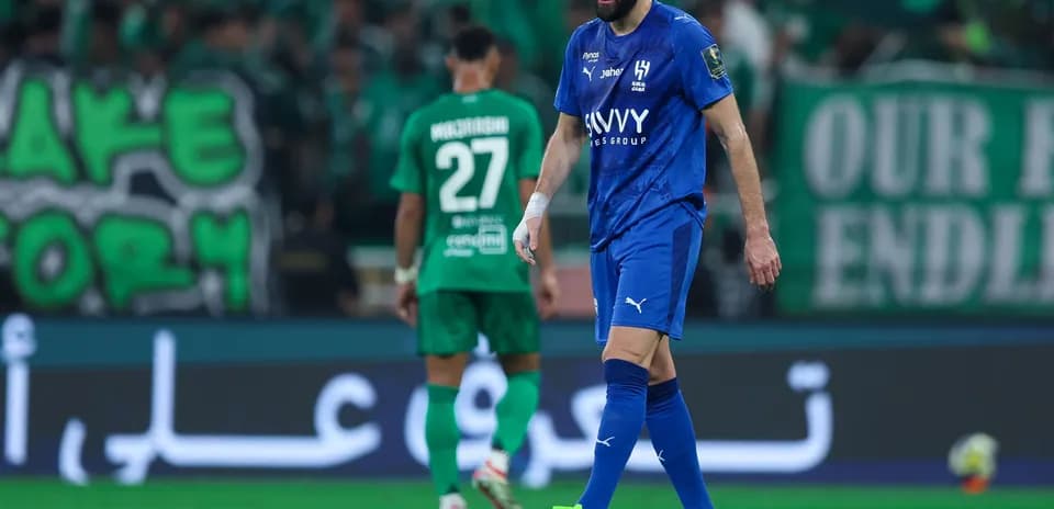 Player in blue jersey walking on the pitch