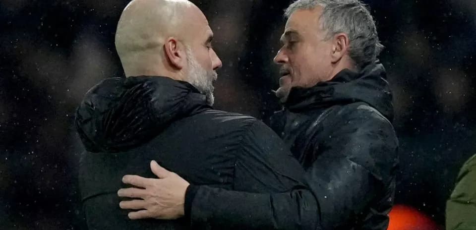 Two coaches embracing after a match