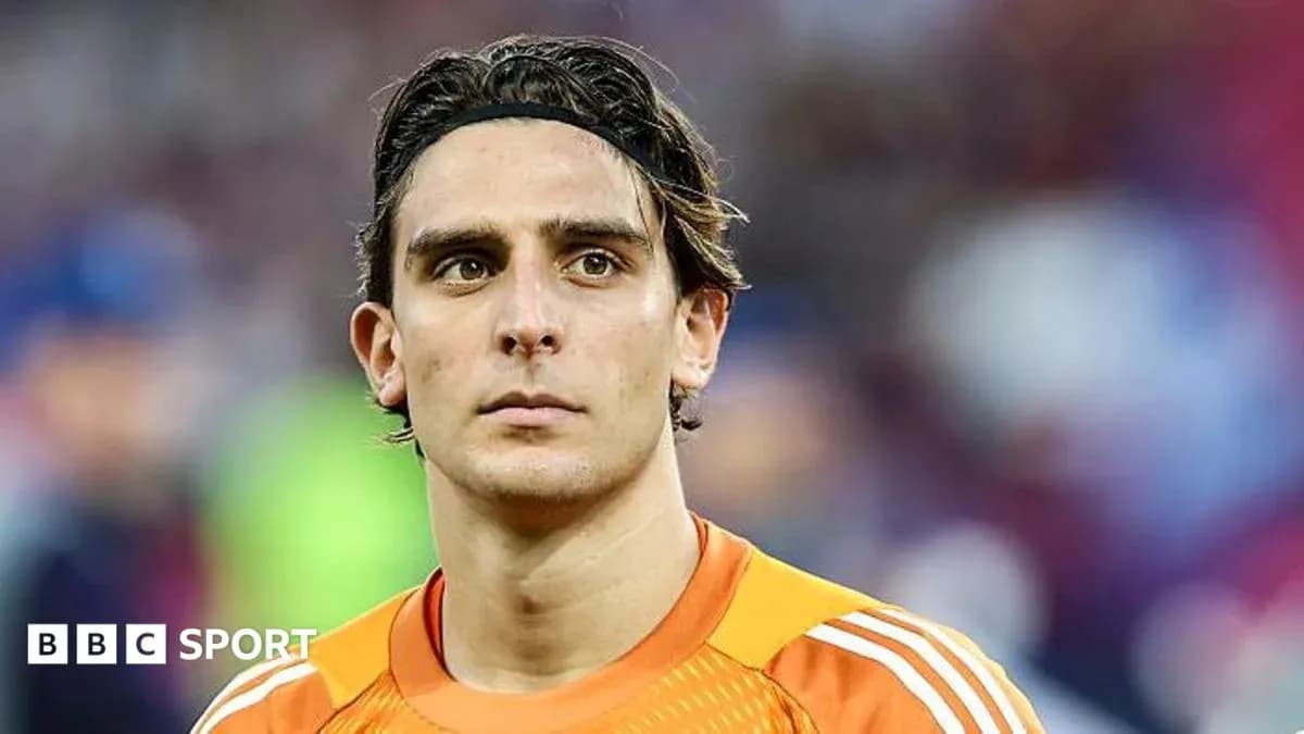 Goalkeeper in orange kit during match preparation