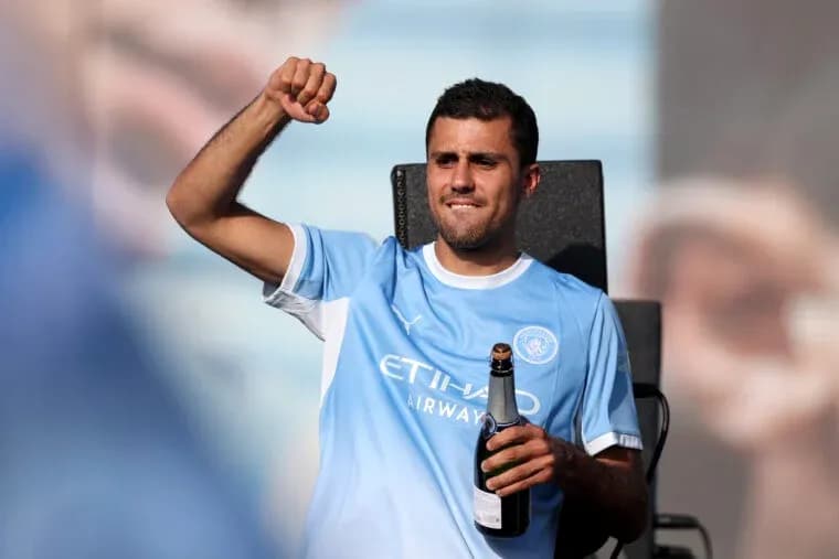 Player celebrating with champagne in team jersey