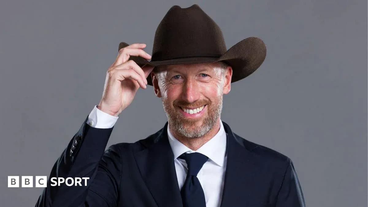Man in suit tipping his cowboy hat