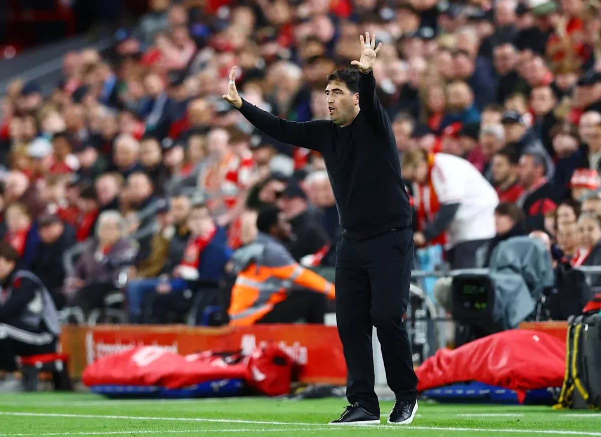 Coach gesturing during a football match on the sidelines