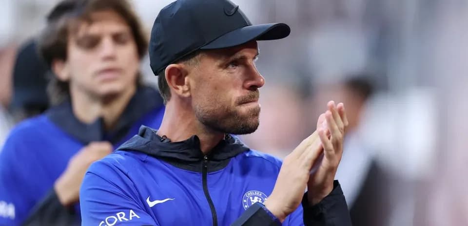 Coach applauding on the sidelines during match