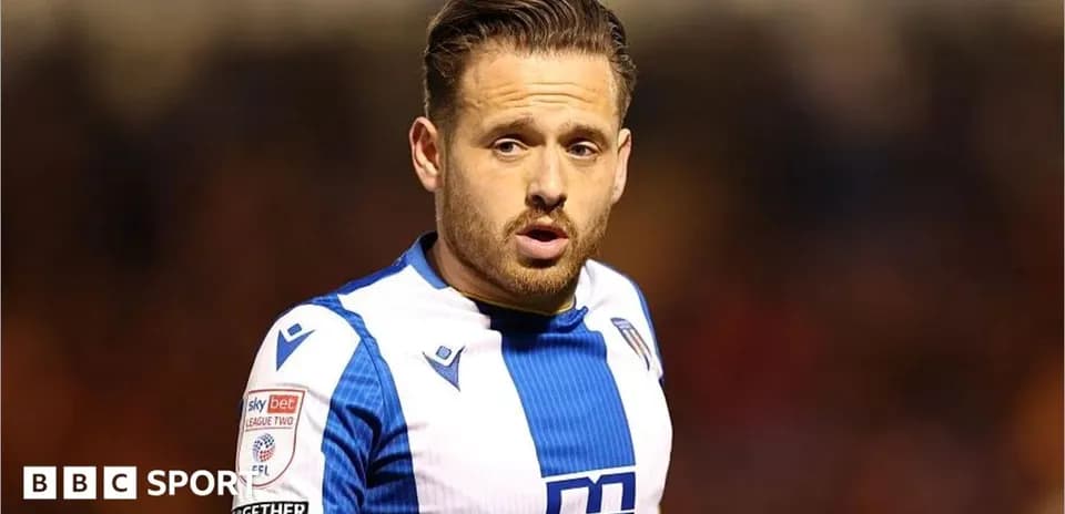 Player wearing blue and white kit on the field