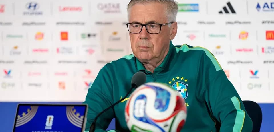 Manager speaking at press conference with soccer ball