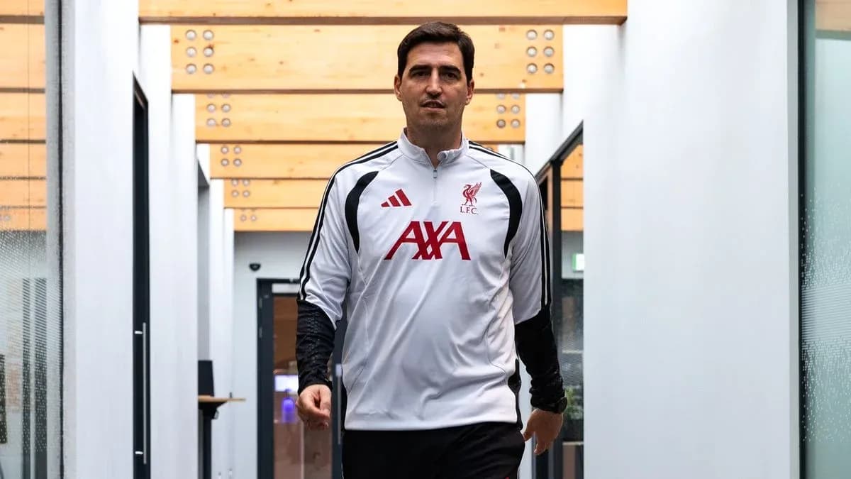 Coach walking through training facility corridor