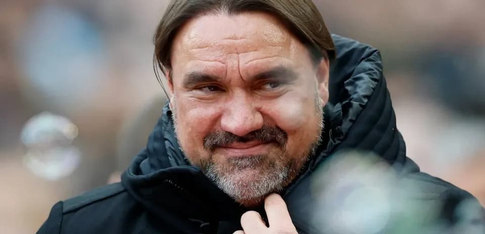 Man in black jacket smiling during event
