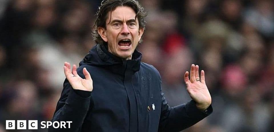 Coach gesturing during a match on the sidelines