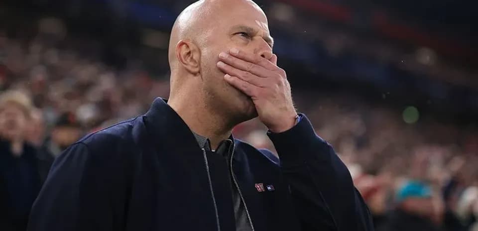 Man covering mouth while watching a match