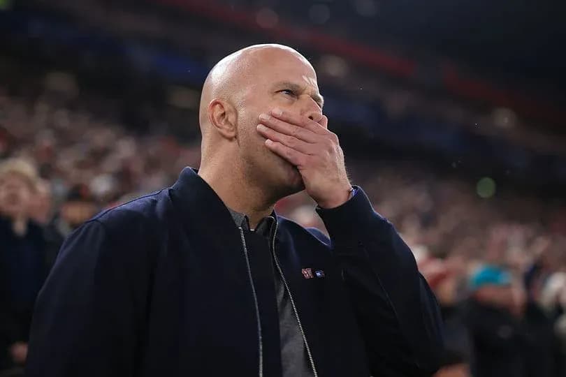 Man covering mouth while watching a match