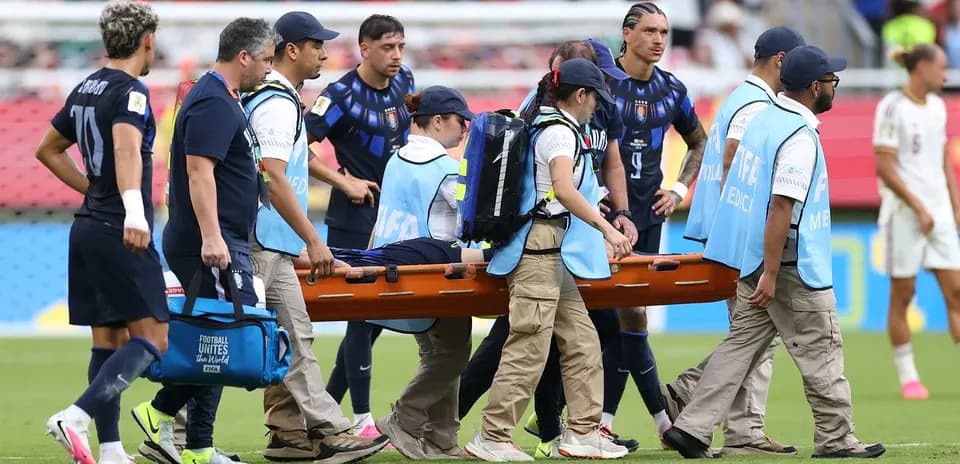 Medical team carrying stretcher off the field
