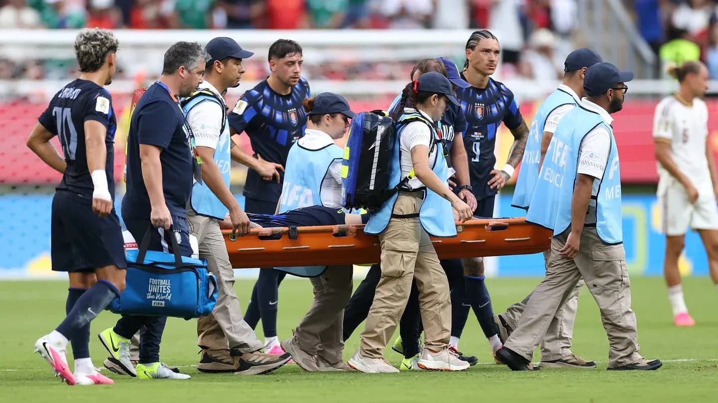 Medical team carrying stretcher off the field
